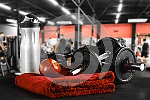 Dumbbell, barbell and workout in the gym. Space for products and decorations or text with blurred gym background. photo