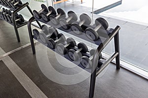 Dumbbell set. Many metal dumbbells on rack in sport fitness center. Weight Training Equipment concept.  Fitness equipment dumbbell