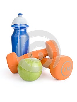 Dumbbell, water bottle and apple