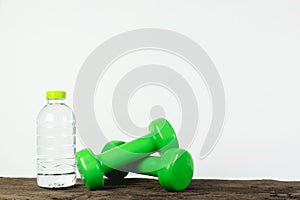 Dumbbell and water bottle on wooden for exercise,gym or healthy