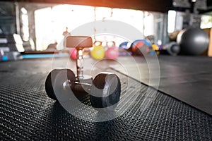 Dumbbell weight training equipment with blurry background, Healthy life and gym exercise equipments and sports concept, with copy