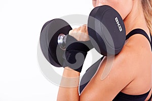 Dumbbell in a woman's hand close up