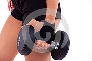 Dumbbell in a woman's hand close up