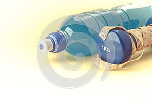 Dumbbell with yellow centimeter and bottle/blue dumbbell with ce