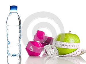 Dumbbells, apple, measure tape and bootle of water