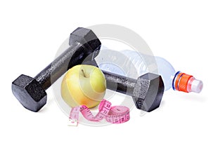 Dumbbells, apples, centimeter and bottle