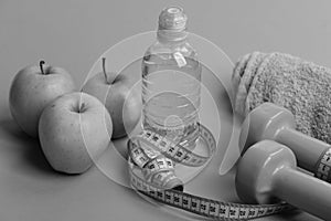 Dumbbells in bright green color, water bottle, measure tape, towel