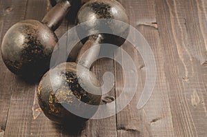 Dumbbells in fitness gym/Dumbbells in fitness gym on a dark wood