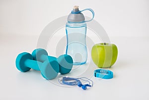 Dumbbells, fitness tracker, earphones and bottle