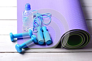 Dumbbells and jump rope in cyan blue color