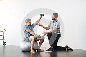 Dumbbells, physiotherapy and exercise with doctor and old man for rehabilitation, training and balance. Health, pain and