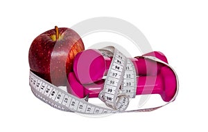 Dumbbells, red apple and measure tape isolated on white