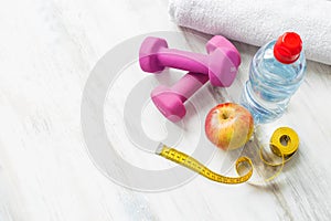 Dumbbells, water, towel, apple, and tape measure