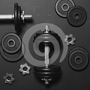 Dumbbells or weights on black table - Concept for workout - Flat lay minmal design