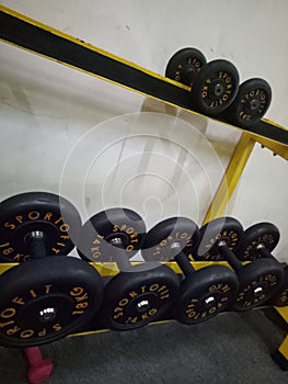 Dumbel set on the gym black yellow photo
