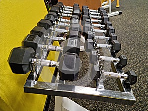 Dumbells on a metal rack in the gym