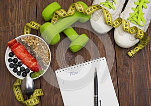 Dumbells, tape measure and healthy food. Fitness