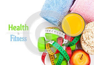 Dumbells, tape measure, healthy food and towels. Fitness and health