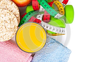 Dumbells, tape measure, healthy food and towels. Fitness and health