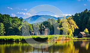 Dumbrava, Sibiu, Romania: Landscape of a lake with windmill