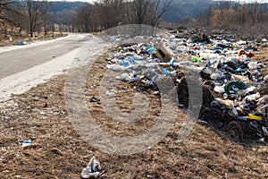 A dump of garbage left on the side of the road to understand the ecological concept