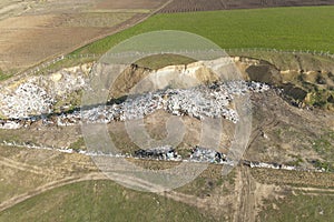 a dump landfill located near the wheat plantation, dumping waste in the prohibited area. arable land,