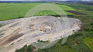 dump in the middle of the field. removal of household and construction waste from the city. aerial view