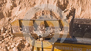 Dump truck being loaded with soil by shovel.