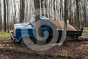 Dump truck car stuck in mud on road. Blurry mud bad road in the park. ÃÂ¢ruck dump car with sand stopped due to wet dirty on