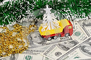 Dump truck and christmas toys on the background from dollars