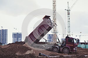 Dump truck is dumping sand