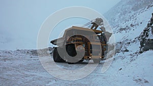 Dump truck loaded with an excavator