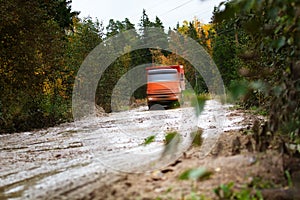 The dump truck moves on a muddy road