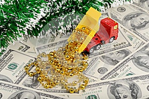 Dump truck and new year toys on the dollars background