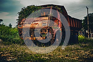 a dump truck that is no longer used and abandoned on the side of a residential road in the Depok area, West Java, Indonesia