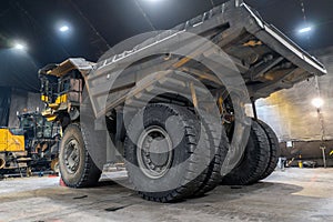 Dump truck is serviced in an industrial garage. photo