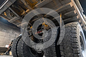 Dump truck is serviced in an industrial garage. photo