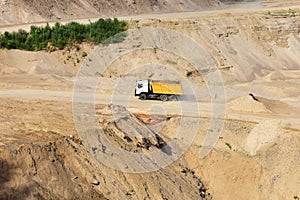 Dump truck transports sand in open pit mine. In the production of concrete, concrete for the construction using coarse sand.