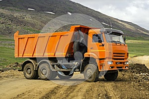 Dump truck is turns on a mountain road