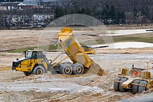 dump truck unloading sand in a quarry