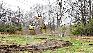 Dump Truck Unloading Soil on Dirt Ramp