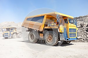 Dump trucks moving in a mine