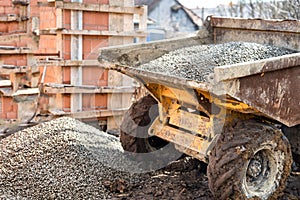 Dumper truck unloading construction gravel, sand and curshed stones