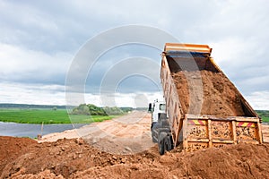 Dumper truck unloading soil