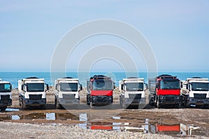 Dumper trucks or tippers on construction site or earthmoving at shore protection works in Batumi