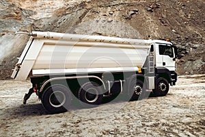 Dumper trucks unloading gravel on highway construction site