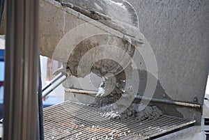 Dumping concrete in pumper machine photo