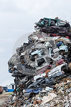 Dumping ground. Scrap metal heap. Compressed crushed cars is returned for recycling.