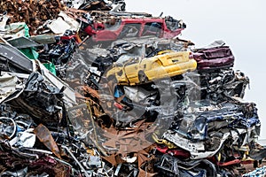 Dumping ground. Scrap metal heap. Compressed crushed cars is returned for recycling. Iron waste ground in the industrial area.