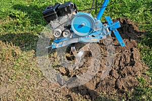 Dumping of land in the garden with a cultivator